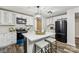 Stylish kitchen with white cabinets, black island and stainless steel appliances at 3366 Table Rock Dr, Gastonia, NC 28052