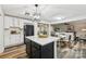 Open kitchen boasts white cabinets, black island, and stylish light fixture at 3366 Table Rock Dr, Gastonia, NC 28052