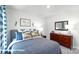 Well-lit bedroom featuring a full-size bed, dresser and wall art at 3929 Coleman Dr, Charlotte, NC 28215