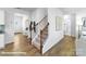 Elegant staircase with dark metal balusters and carpeted steps at 3929 Coleman Dr, Charlotte, NC 28215