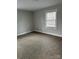 Simple bedroom with carpeted floor and a window at 407 E Talleyrand Ave, Monroe, NC 28112