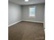 Bright bedroom with neutral walls and carpet at 407 E Talleyrand Ave, Monroe, NC 28112