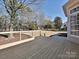 Large wooden deck with railing overlooking the backyard at 4407 Esherwood Ln, Charlotte, NC 28270