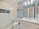 Modern bathroom with a white tiled shower, glass door, and updated vanity at 4407 Esherwood Ln, Charlotte, NC 28270