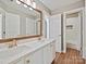 Bathroom featuring double sinks, wood floors, and a large mirror at 4407 Esherwood Ln, Charlotte, NC 28270