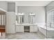 Well-lit bathroom featuring dual vanities, a soaking tub, and neutral tones at 4407 Esherwood Ln, Charlotte, NC 28270