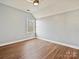 Light and airy bedroom with wood floors and a window at 4407 Esherwood Ln, Charlotte, NC 28270