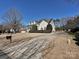 Traditional home with a welcoming front porch, manicured landscaping, and a long driveway leading to the two-car garage at 4407 Esherwood Ln, Charlotte, NC 28270