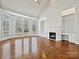 Bright living room with fireplace, built-ins, hardwood floors and bay window at 4407 Esherwood Ln, Charlotte, NC 28270