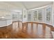 Open-concept living room with hardwood floors, fireplace, and large windows at 4407 Esherwood Ln, Charlotte, NC 28270