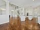 Open-concept living room with fireplace, staircase, and view into the kitchen at 4407 Esherwood Ln, Charlotte, NC 28270