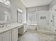 Luxurious main bathroom with dual vanities, soaking tub, and a tiled shower at 4407 Esherwood Ln, Charlotte, NC 28270