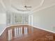 Spacious main bedroom featuring hardwood floors, tray ceilings, and natural light at 4407 Esherwood Ln, Charlotte, NC 28270