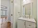 Charming powder room featuring white vanity and natural lighting at 4407 Esherwood Ln, Charlotte, NC 28270