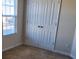 Bedroom with double doors and neutral walls and carpet at 4529 Esmeralda Dr, Charlotte, NC 28269