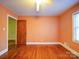 Bedroom with hardwood floors and peach walls at 48374 Pfeiffer Pl, Misenheimer, NC 28109