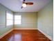 Bedroom with hardwood floors and two windows at 48374 Pfeiffer Pl, Misenheimer, NC 28109