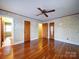 Spacious bedroom with hardwood floors and multiple doors at 48374 Pfeiffer Pl, Misenheimer, NC 28109