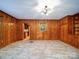 Dining room with wood paneling, tile floor, and built-in shelving at 48374 Pfeiffer Pl, Misenheimer, NC 28109