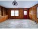 Dining room with wood paneling, tile floor, and built-in shelving at 48374 Pfeiffer Pl, Misenheimer, NC 28109