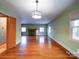 Hardwood floors and view into living room with fireplace at 48374 Pfeiffer Pl, Misenheimer, NC 28109