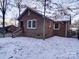 Backyard view of brick home with snowy ground at 48374 Pfeiffer Pl, Misenheimer, NC 28109