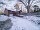 Home back view with garage and snowy yard at 48374 Pfeiffer Pl, Misenheimer, NC 28109