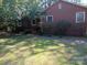 Brick ranch home with mature trees and a grassy yard at 48374 Pfeiffer Pl, Misenheimer, NC 28109