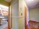 Light green hallway with hardwood floors and access to bathroom and bedrooms at 48374 Pfeiffer Pl, Misenheimer, NC 28109