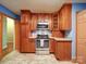 Kitchen with wood cabinets, stainless steel appliances, and tile flooring at 48374 Pfeiffer Pl, Misenheimer, NC 28109