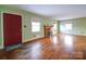 Spacious living room featuring hardwood floors, a fireplace, and large windows at 48374 Pfeiffer Pl, Misenheimer, NC 28109