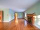 Hardwood floors and a fireplace feature in this living room at 48374 Pfeiffer Pl, Misenheimer, NC 28109