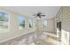 Sun-drenched sunroom with tile flooring and ceiling fan at 507 Bearbrook Ln, Gastonia, NC 28052