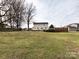 Huge backyard with green grass and scattered mature trees creating a peaceful setting at 509 Baucom Deese Rd, Monroe, NC 28110