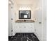 Bathroom featuring granite countertop vanity, framed mirror, and black and white tiled floor at 509 Baucom Deese Rd, Monroe, NC 28110