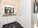 Bathroom featuring a white vanity with granite countertop and a decorative mirror in a well-lit space at 509 Baucom Deese Rd, Monroe, NC 28110