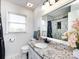 Bright bathroom showcasing shower with black hardware, granite counter, and natural light from the window at 509 Baucom Deese Rd, Monroe, NC 28110