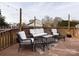 Outdoor living with this spacious deck featuring wicker furniture set and neutral area rug at 509 Baucom Deese Rd, Monroe, NC 28110