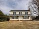 Two-story house with beige vinyl siding, dark shutters, and a brick foundation at 509 Baucom Deese Rd, Monroe, NC 28110