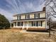 Two-story house with beige vinyl siding, dark shutters, and a brick foundation at 509 Baucom Deese Rd, Monroe, NC 28110