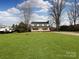 Charming two-story home featuring a welcoming front porch and lush green lawn at 509 Baucom Deese Rd, Monroe, NC 28110