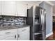 Modern kitchen features stainless steel refrigerator, granite countertops, and sleek backsplash at 509 Baucom Deese Rd, Monroe, NC 28110