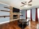 Living room with brick fireplace, hardwood floors, and a ceiling fan at 509 Baucom Deese Rd, Monroe, NC 28110