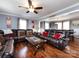 Spacious living room with hardwood floors, leather sectional sofa, and large windows at 509 Baucom Deese Rd, Monroe, NC 28110