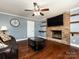 Spacious living room features a brick fireplace, hardwood floors, and built-in shelving at 509 Baucom Deese Rd, Monroe, NC 28110