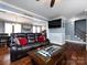 Spacious living room featuring a leather couch and hardwood floors at 509 Baucom Deese Rd, Monroe, NC 28110