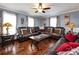 Inviting living room with a large leather sectional, hardwood floors, and soft, natural light at 509 Baucom Deese Rd, Monroe, NC 28110