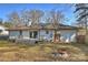 Back of the house with a deck and sliding glass doors, as well as a brick patio at 532 Scaleybark Rd, Charlotte, NC 28209