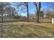 Spacious backyard with fenced perimeter, fire pit, and mature trees at 532 Scaleybark Rd, Charlotte, NC 28209