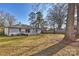 Expansive backyard with mature trees, providing shade and a serene outdoor space at 532 Scaleybark Rd, Charlotte, NC 28209